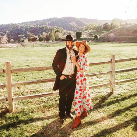 Cobie Smulders and Taran Killam are posing in a cowboy outfit.